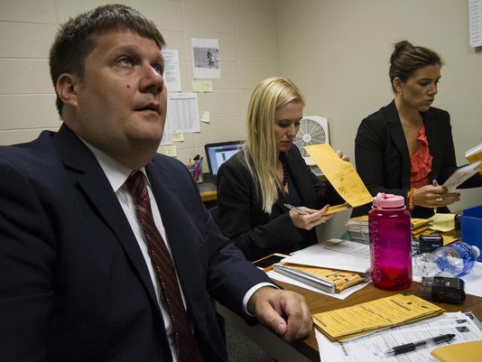 Assistant Commonwealth Attorneys John Balenovich, left, and Diane Arnold, center, review cases for the new rocket docket while working alongside Felony Pilot Project Prosecutor Jessica Moore in their shared offices. (Photo: Matt Herp, Special to the C-J)
